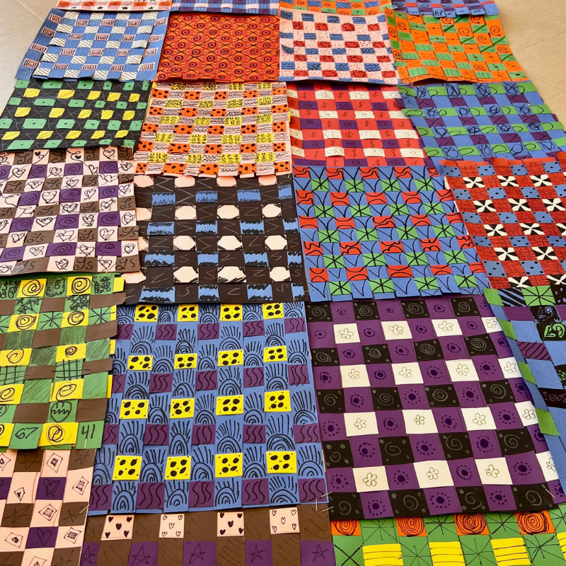 A colorful collection of woven paper squares with diverse patterns and designs.