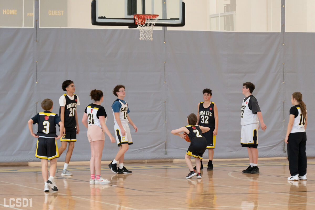 A student prepares to take a shot in a basketball game.