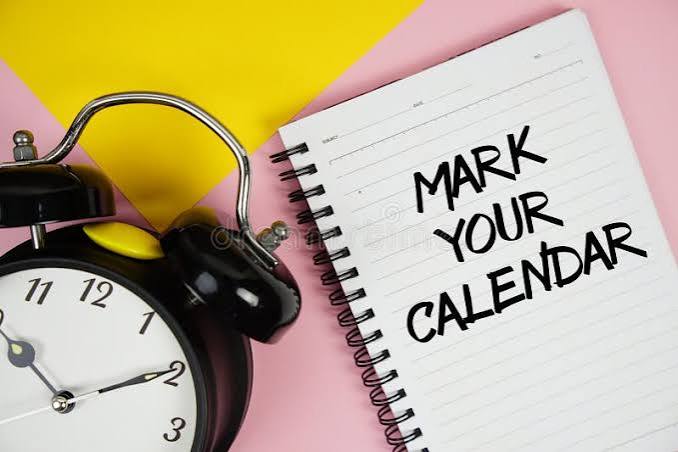A black alarm clock sits beside a spiral notebook with "Mark Your Calendar" written on it, set against a pink and yellow background.