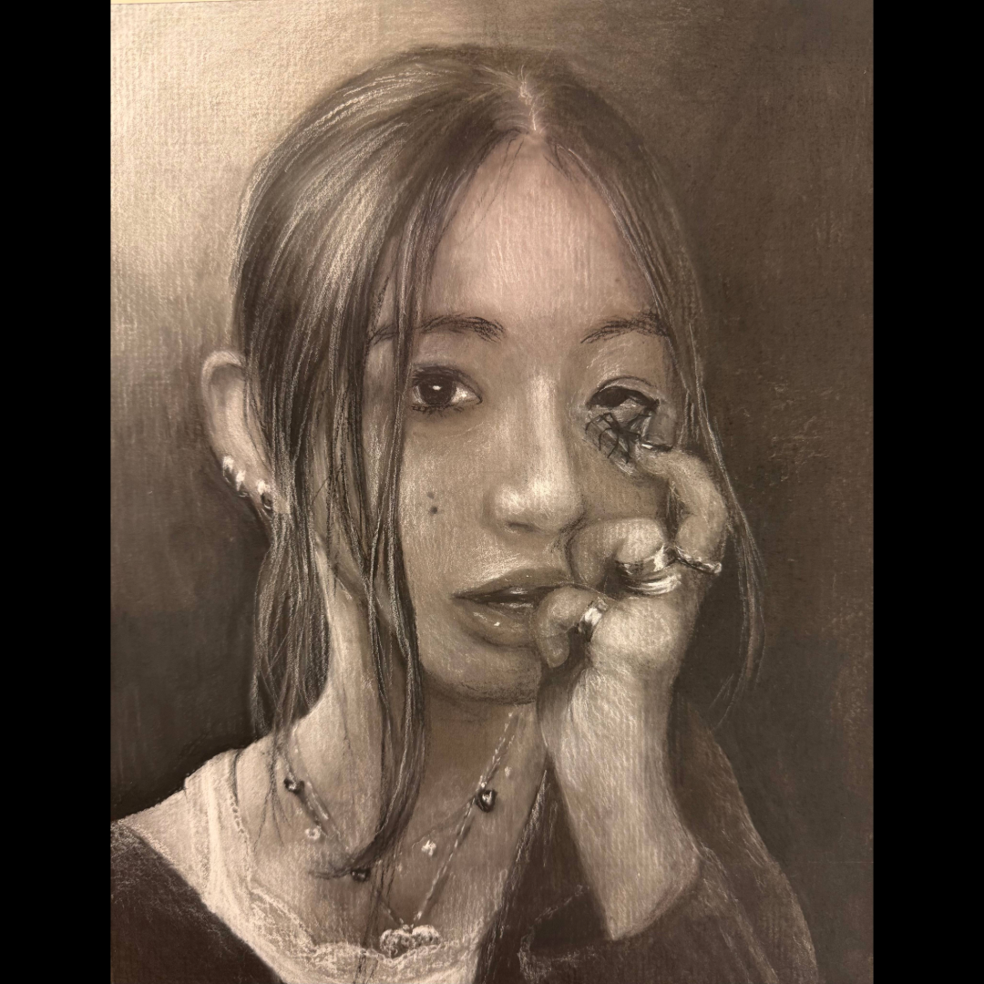 Charcoal portrait of a young woman with dark hair, looking directly at the viewer.
