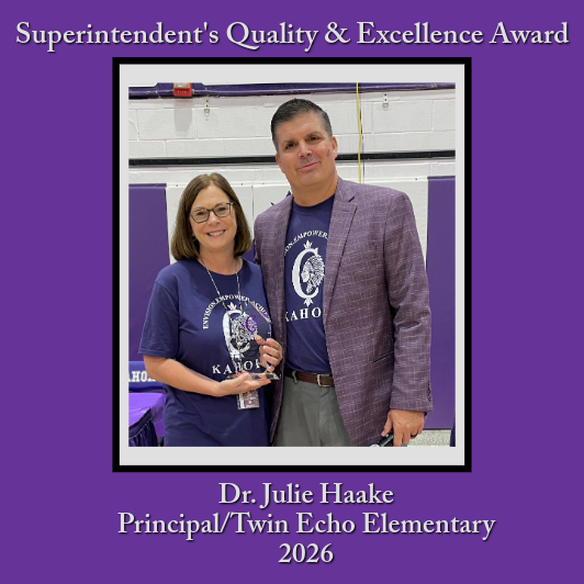 A woman and a man stand together, holding a glass award, with text indicating "Superintendent's Quality & Excellence Award".