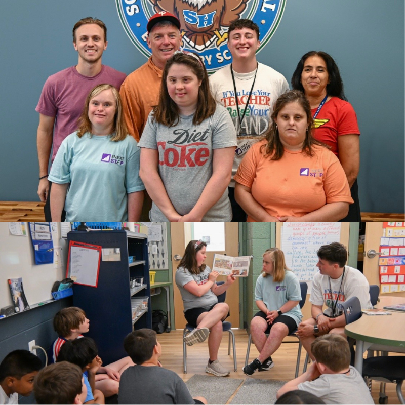 A group of students and adults pose for a photo in front of a school logo.