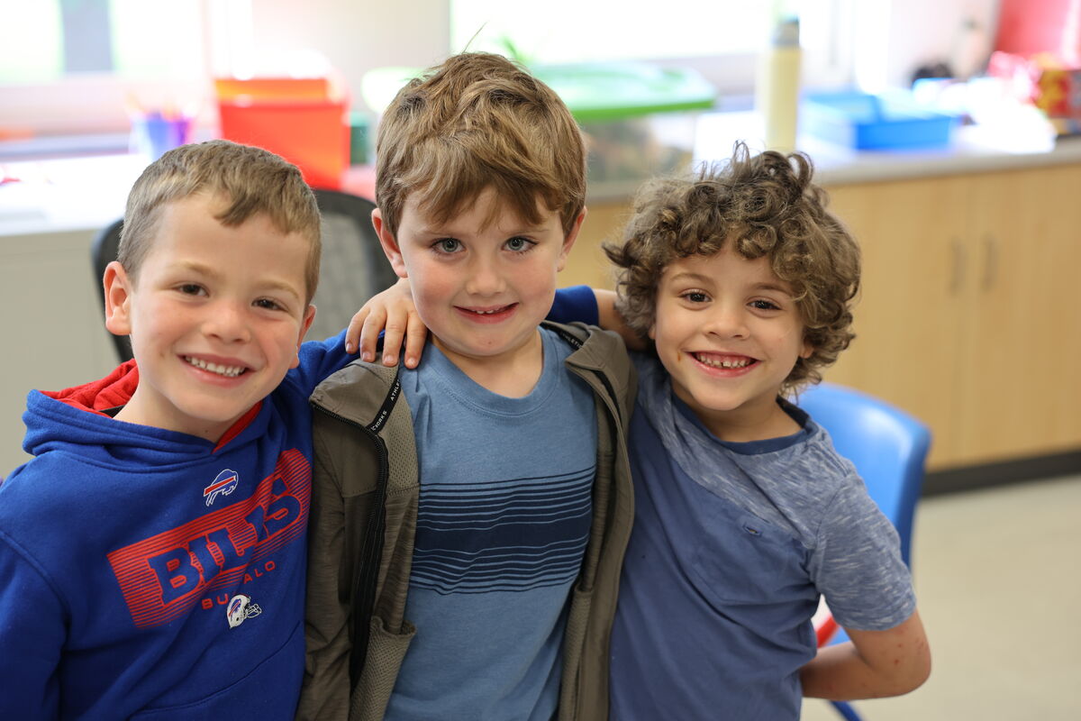 Three students smile