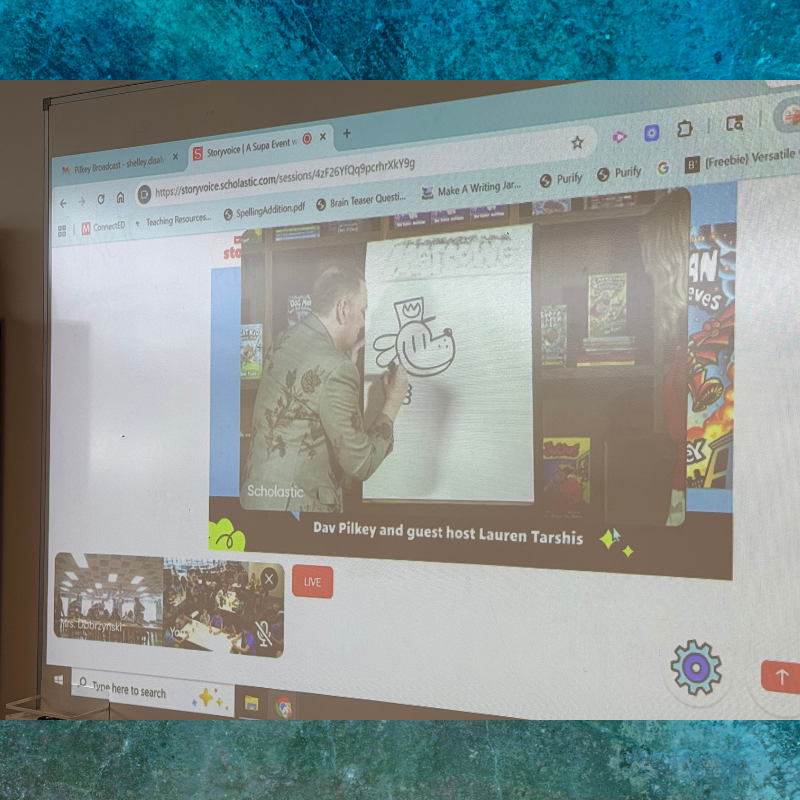 Dav Pilkey draws a character on a whiteboard during a Scholastic Storyvoice broadcast.