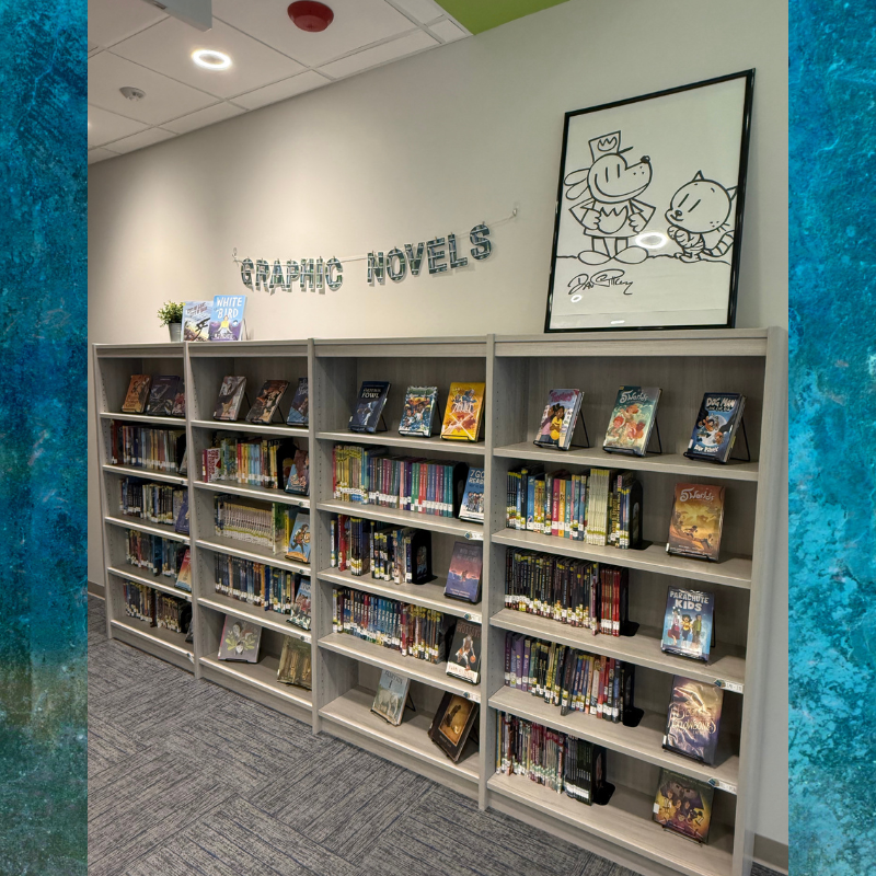 A library section displays shelves filled with graphic novels, with a banner reading 'GRAPHIC NOVELS' above.