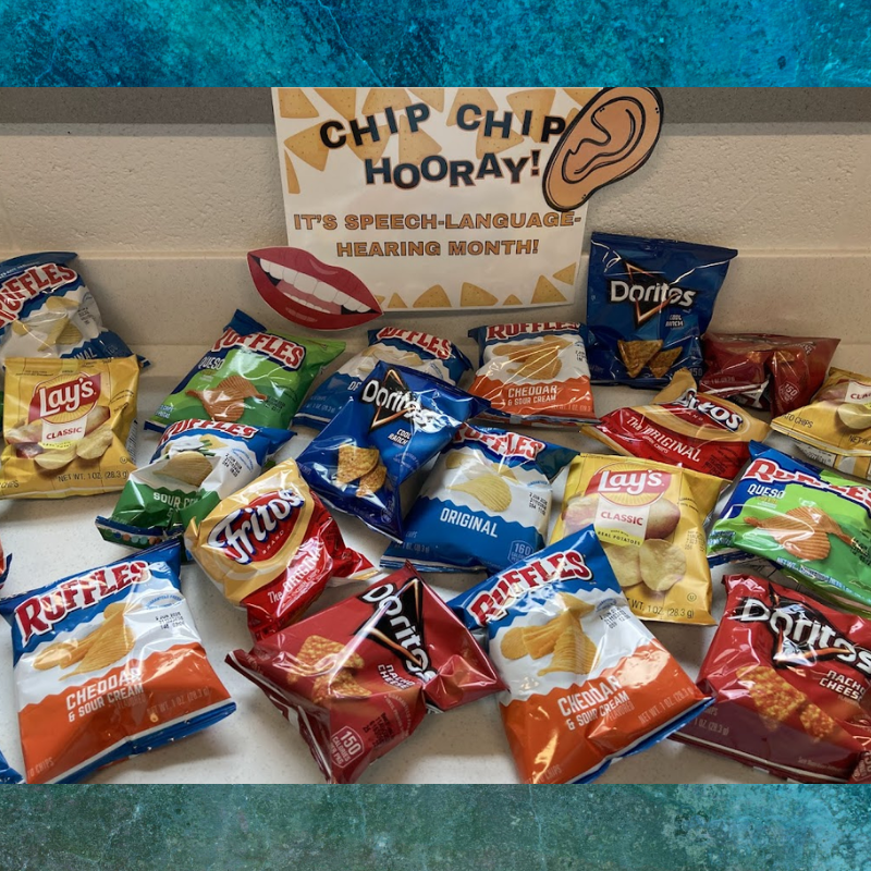 A variety of chip bags, including Lay's, Doritos, Ruffles, and Fritos, are displayed with a sign celebrating Speech-Language-Hearing Month.