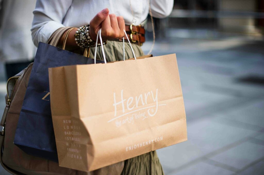 A woman carrying a bundle of shopping bags