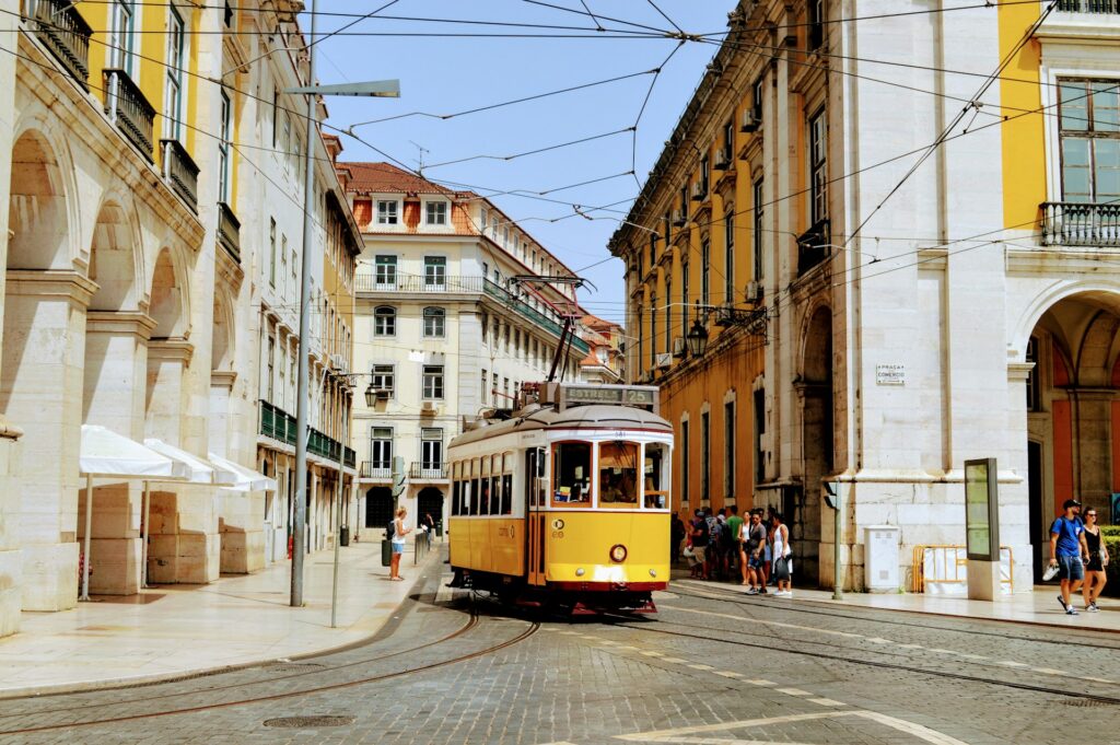 A tram running down clear streets in Lisbon