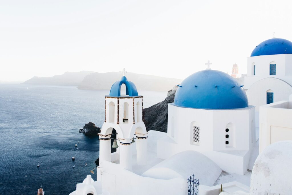 Blue and white buildings on a clifftop