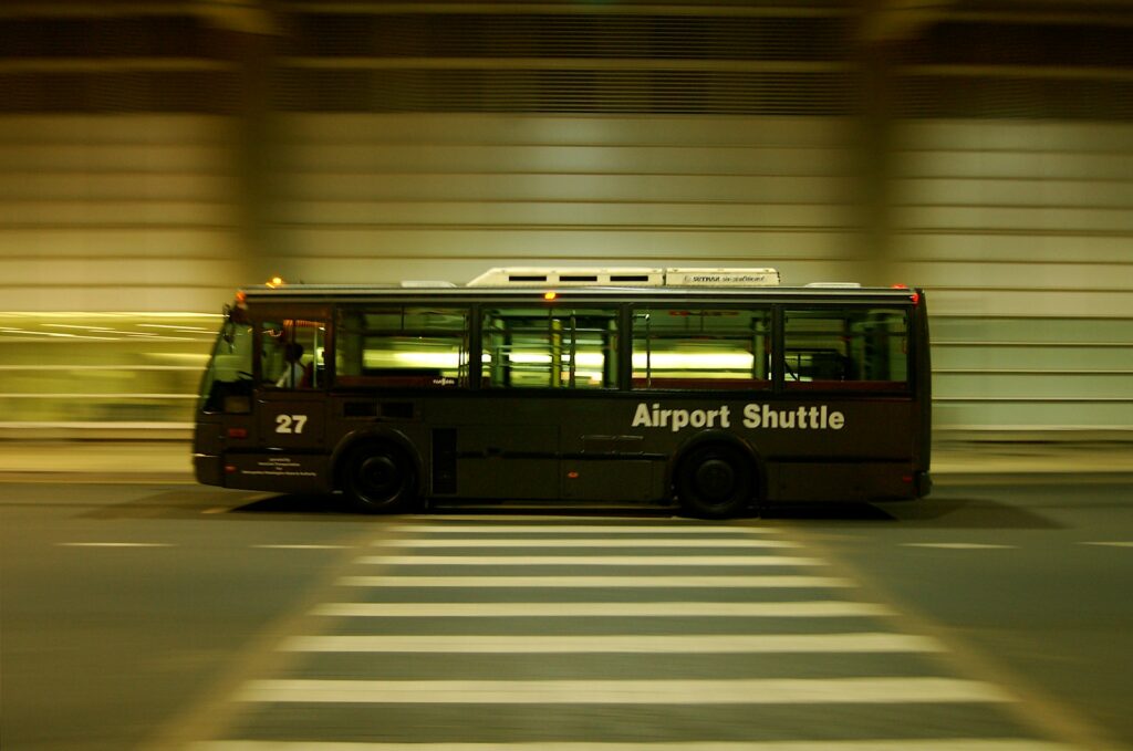 An airport shuttle bus driving through a tunnel