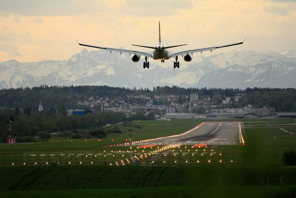 A plane landing on a lit up runway