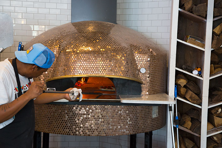 1889 pizzas are baked for 90 seconds in a wood-burning oven imported from Italy.