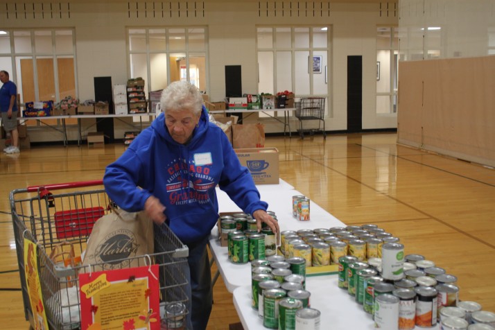 Ruth Higgins of Mission sorts canned goods going to a needy family for Thanksgiving.