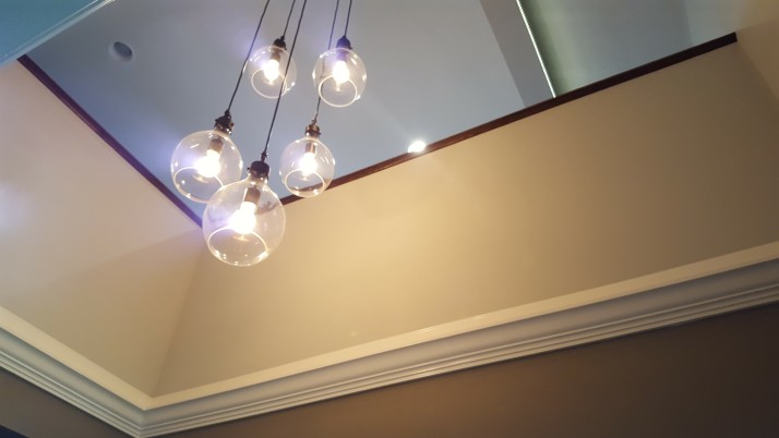 A stylish light fixture hang in the loft entry after the renovation.
