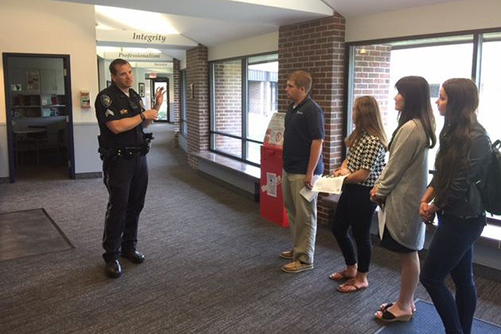 Members of the teen council getting a tour of the Prairie Village Police Department.