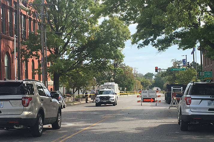 Lawrence police processed the crime scene the morning after the shooting that left three people dead.