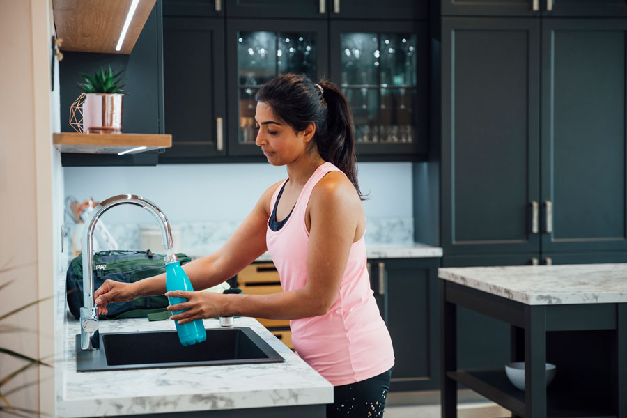 Women filling water bottle with water