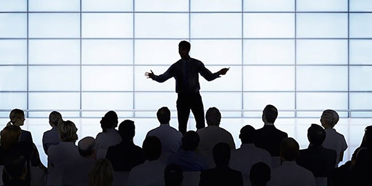 Silhouette of a man addressing a crowd