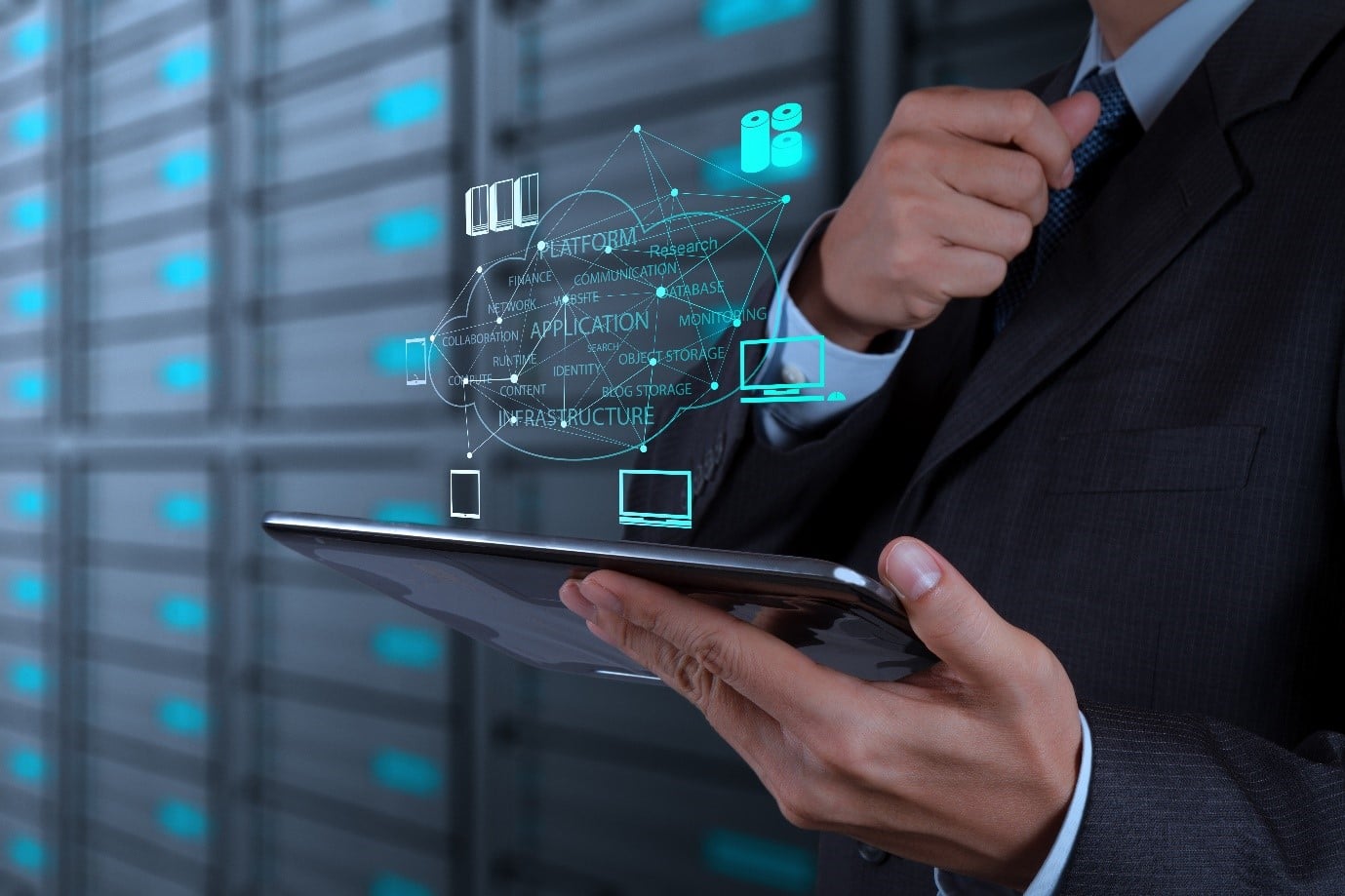 Person holding tablet in front of servers