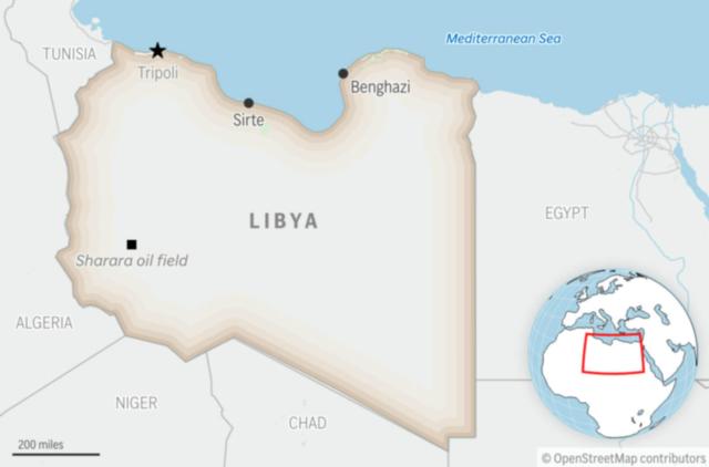 A boat carrying migrants capsizes off Libya's coast, with at least 50 dead or missing