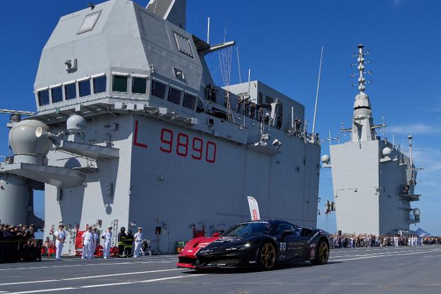 AP News: One man in an Italian supercar atop an aircraft carrier. And a record in his sights