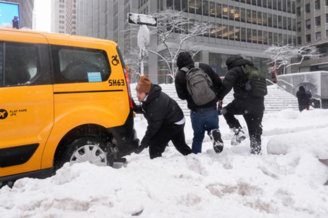 AP News: The Latest: Northeast snowstorm forces millions to stay home, disrupts flights and closes schools