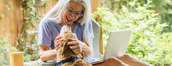 Woman with laptop and dog