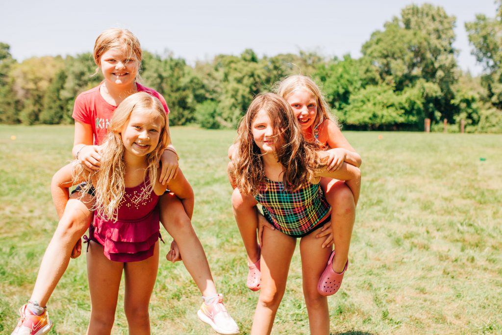 4 young girls pose for a picture at summer camp