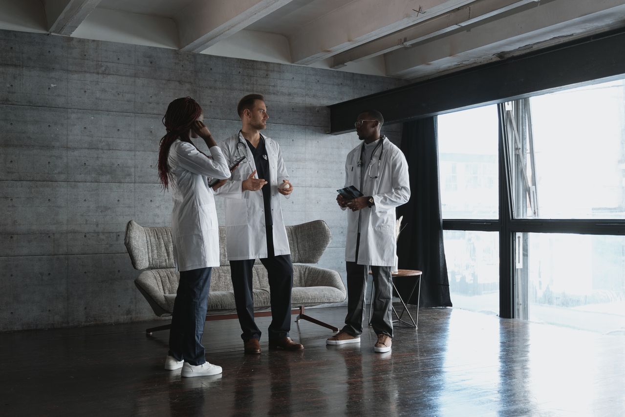 Medical professionals discussing their work together in a clinic.