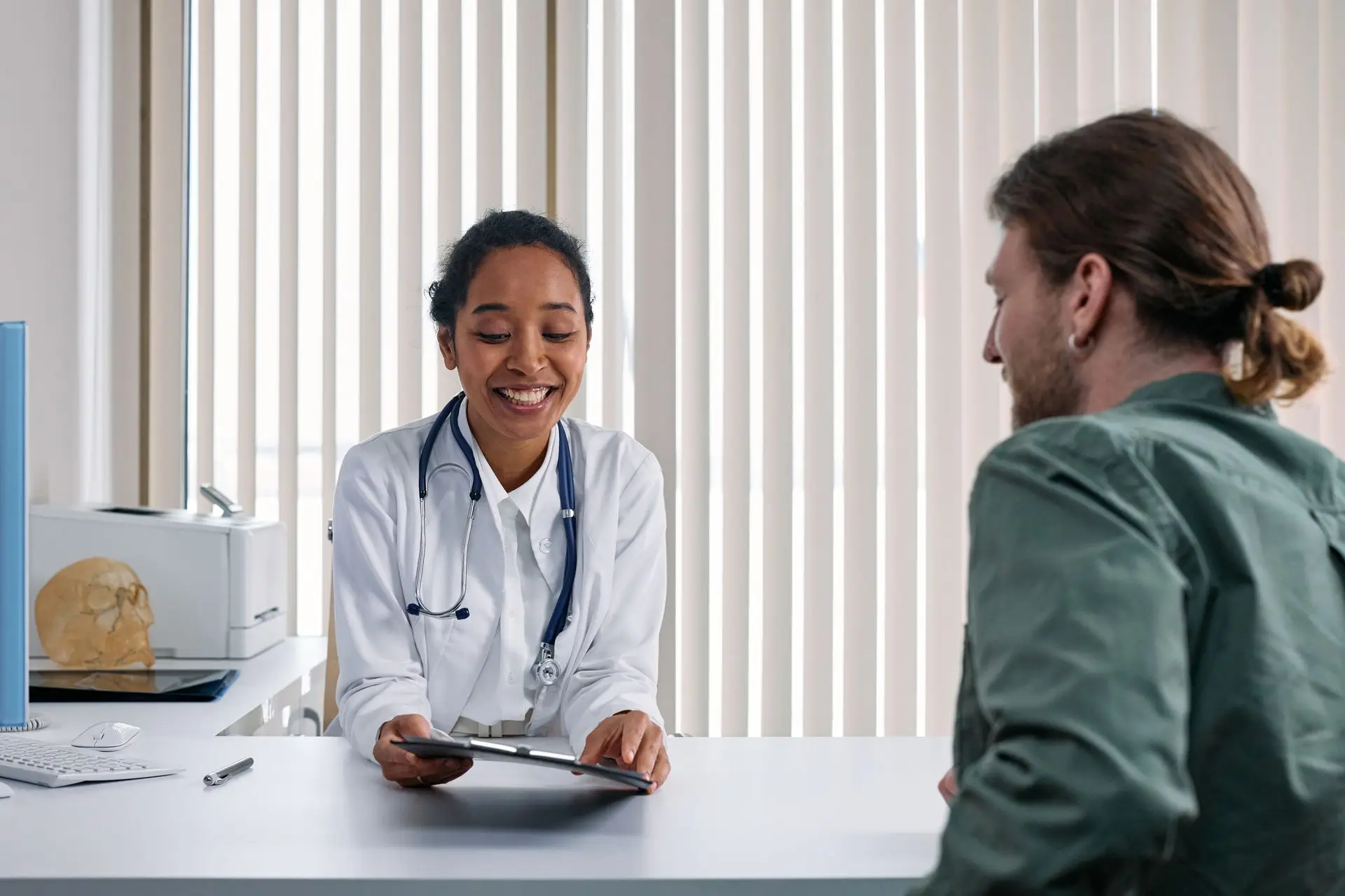 Doctor speaking with a patient during a consultation in a medical office.