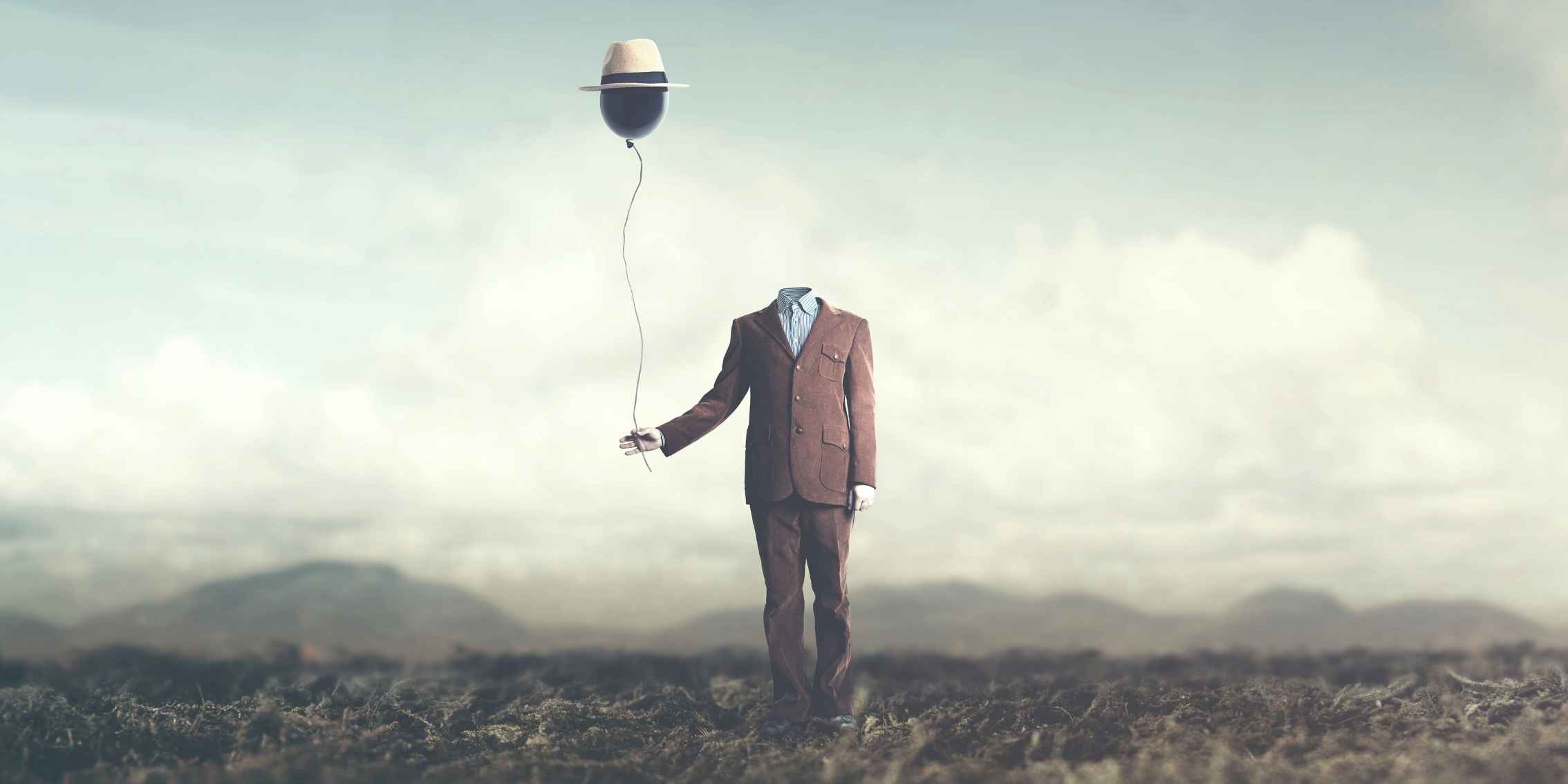 Image manipulation manipulated surrealism image of a headless man in a suit holding a balloon