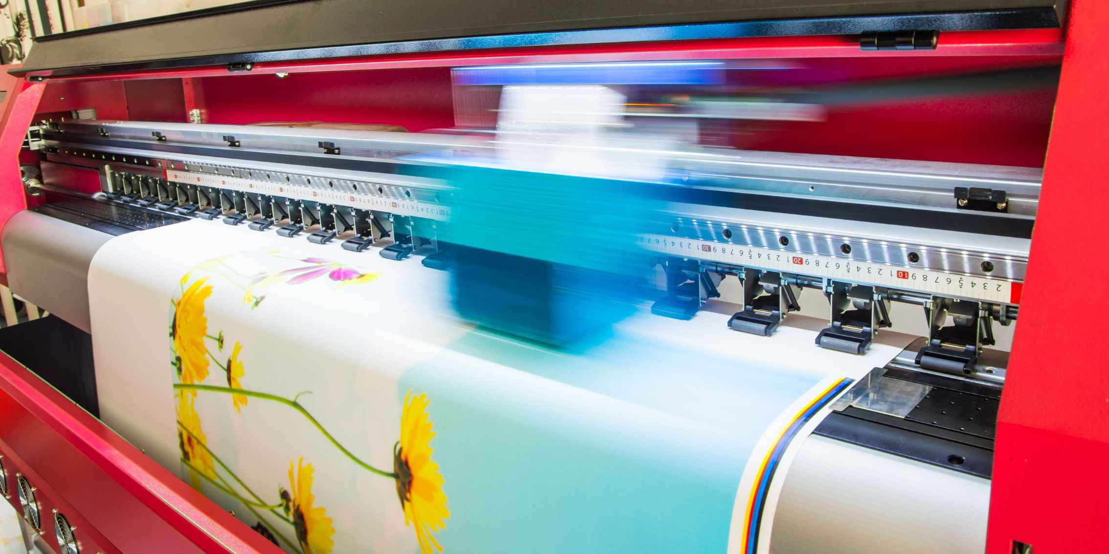 Large format printer printing a floral pattern on a white canvas Large format printer printing a floral pattern on a white canvas