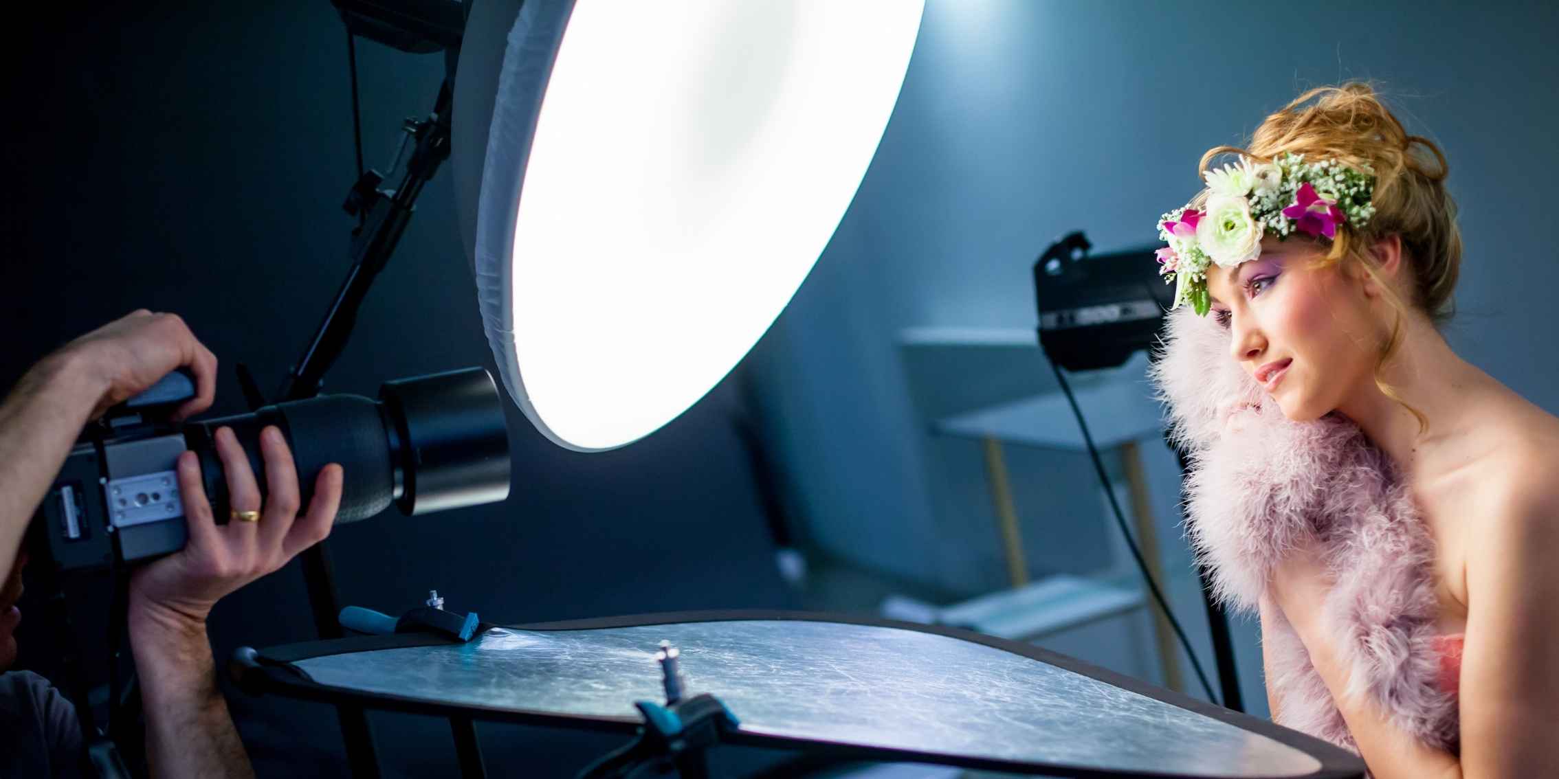 Women with flower headpiece getting her headshot taken in a photography studio Women with flower headpiece getting her headshot taken in a photography studio