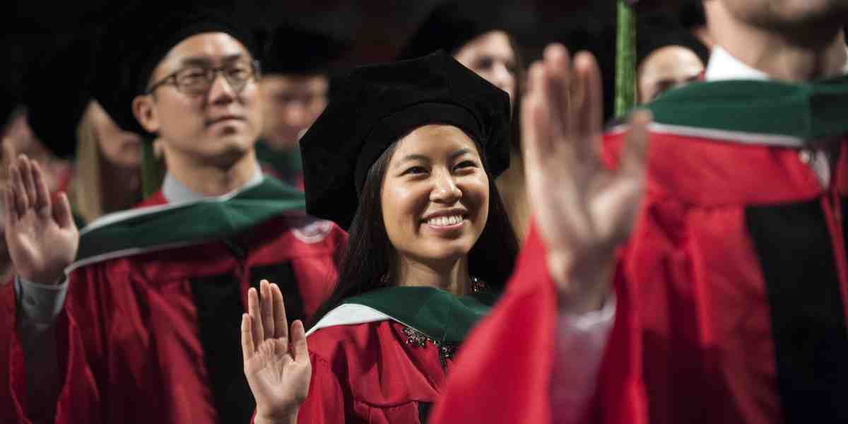 Graduates take the Oath of Geneva during the university's Commencement ceremony on June 3, 2016.