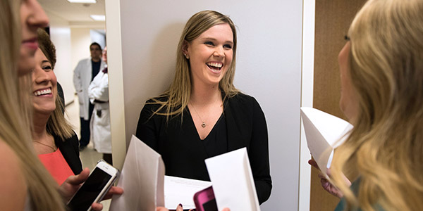 Allison Damon, center, celebrates with Scholl College classmates who matched into medical / surgical residencies.