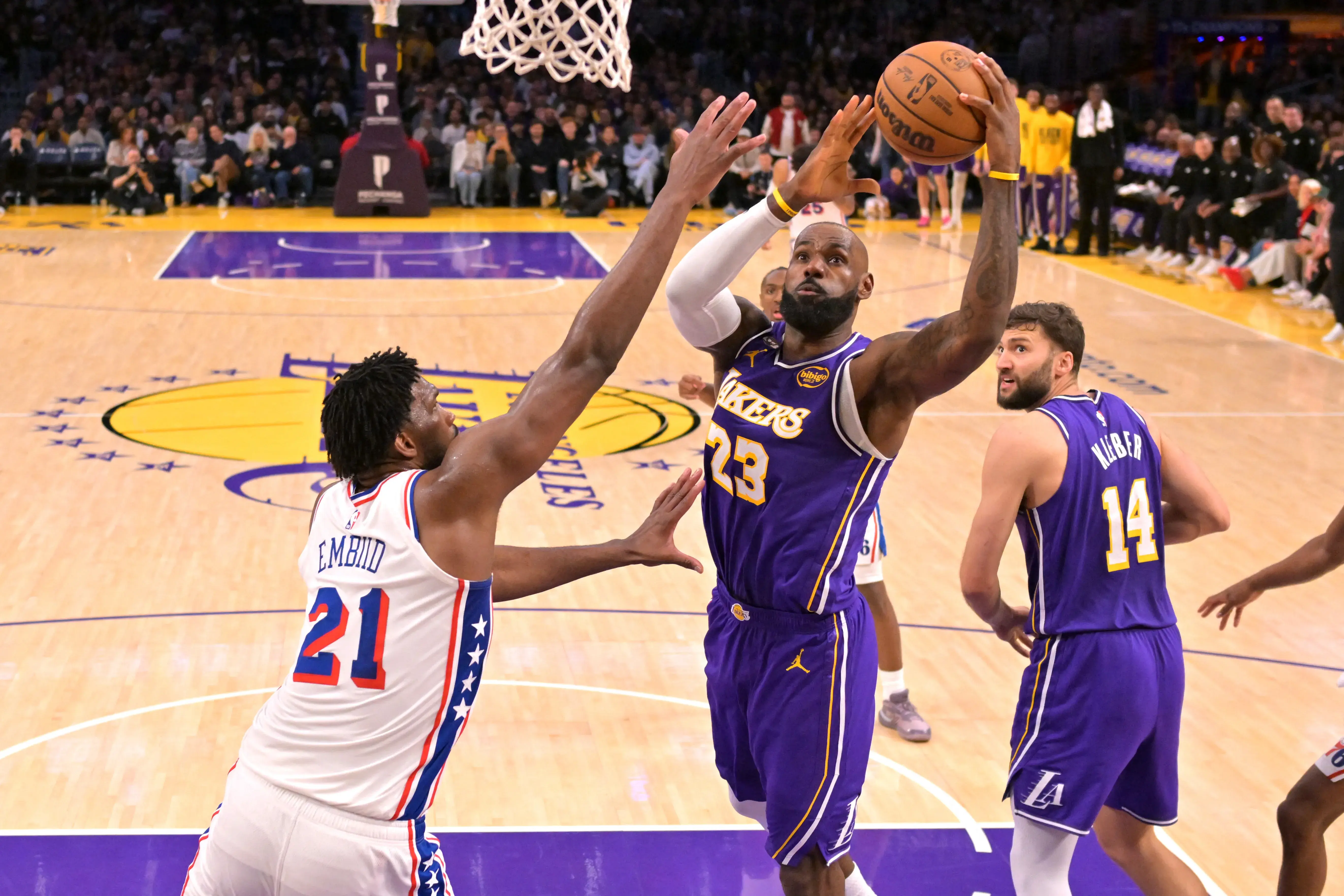 Los Angeles Lakers forward LeBron James (23) drives past Philadelphia 76ers center Joel Embiid (21) in the second half at Crypto.com Arena. Mandatory Credit: Jayne Kamin-Oncea-Imagn Images