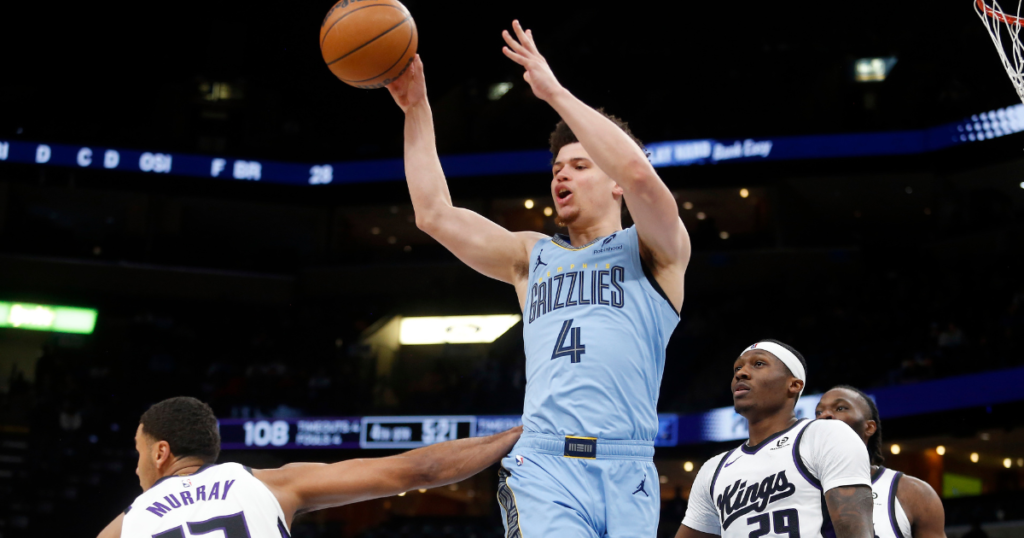 Memphis Grizzlies guard Walter Clayton Jr. (4) passes the ball as Sacramento Kings forward Keegan Murray (13) and guard Daeqwon Plowden (29) defends during the fourth quarter at FedExForum. Mandatory Credit: Petre Thomas-Imagn Images