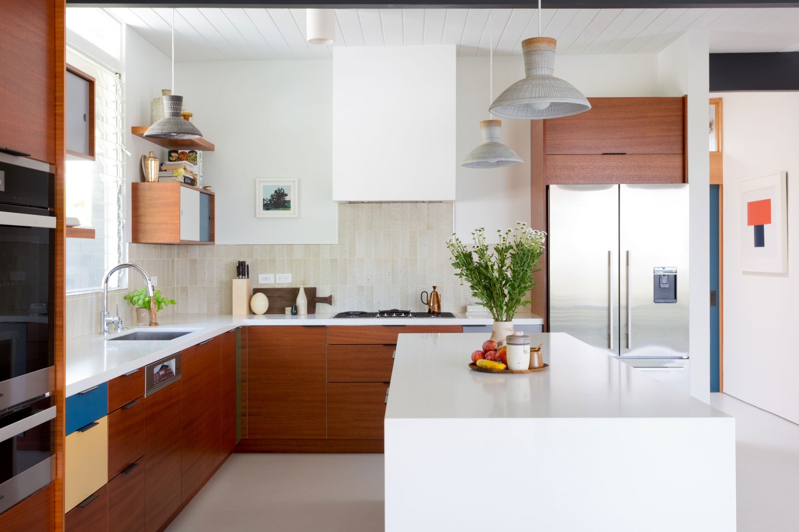 A kitchen with stainless steel appliances and an island.