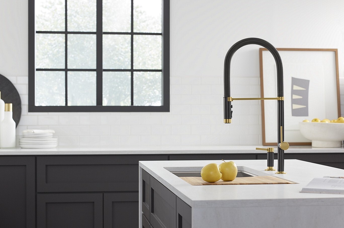 Black and gold kitchen faucet called Juxtapose by Kallista in a modern black and white kitchen