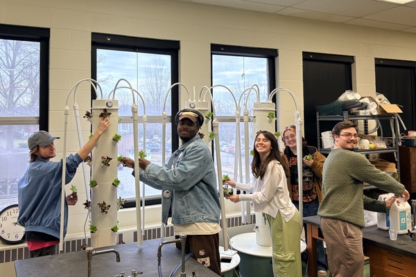 Members of the YHC Gardening Club check on lettuce grown in hydroponic towers in the College's Science department.