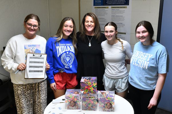 Lindsey Wilson University education professor Jennifer Antoniotti-Neal, center, joins on Thursday, March 19, in the Goodhue Academic Center the winning team of education majors in her “Children’s Literature” class’ “Amazing Race” competition. From left: Amelia Brown ’29 of Columbia; Jadelyn Waggener ’29 of Columbia; Antoniotti-Neal; Alexis Martin ’28 of Bowling Green, Kentucky; and Dale Shaffer ’28 of Albany, Kentucky. The activity reviewed what students studied in the class’ unit on teaching poetry.