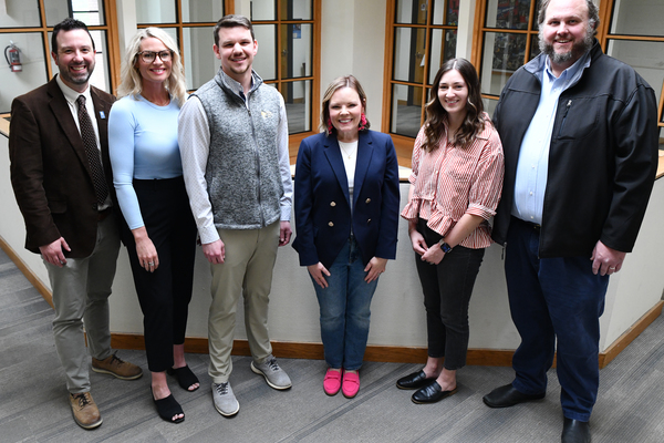 Lindsey Wilson University Dean of the School of Business and Communication Benson Sexton ’04, left, joins five members of the school’s advisory board in the university’s J.L. Turner Leadership Center. From left: Sexton; Paige Nickel ’11, executive director of Adair County Tourism and Convention Commission; Patrick Adkins ’19, the financial controller for South Central Bank Inc. in Glasgow, Kentucky; Lori Riddle Eberenz ’02, Yum! Brands’ head of public relations and global storytelling; Madison Bryant Kirby ’19, Wiley Publishing digital learning executive; and Kyle Edwards ’06, president of Edwards Managed Technology Computer Consulting of Lexington, Kentucky. Not pictured: Andy Mann ’08, assistant vice president, contract administration, HealthTrust Performance Group; Curtis Pelston ’16, parks program services supervisor at Lake Cumberland State Resort; and Chloe Thomas ’22, marketing specialist with MDI-Management Data Inc.