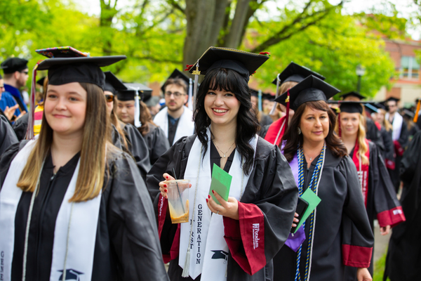 Jocelyn Loomis ’24 processes into Commencement at SUNY Potsdam wearing her first-generation student stole, as she earned her Bachelor of Fine Arts degree in creative writing. SUNY Potsdam recently was named to the FirstGen Forward Network to support first-generation students.