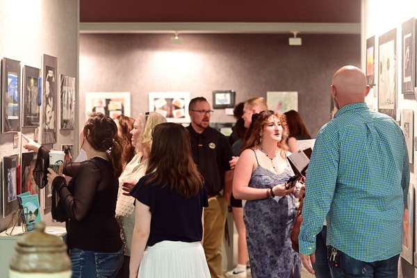 Northeast Mississippi Community College art students view and discuss works during the opening reception of the annual Student Art Show in 2025 at the Anderson Hall Art Gallery. The event gives student artists an opportunity to showcase their work while engaging with attendees and sharing the meaning and inspiration behind their pieces.