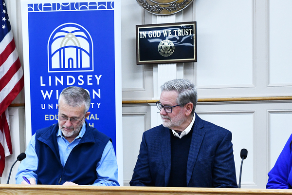 Pulaski County Judge-Executive Marshall Todd, second from left, signs the scholarship agreement between the county government and Lindsey Wilson University on Monday, March 30, in the Pulaski County Courthouse. Looking on are, from left: Lindsey Wilson Coordinator of Educational Outreach Penny Rizenbergs, Lindsey Wilson counseling professor Daniel Melear and Lindsey Wilson Regional Enrollment Director for Educational Outreach Cheryl Boger.