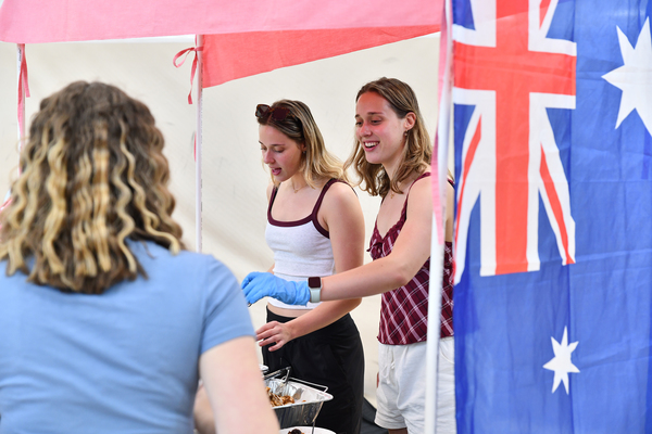 Lindsey Wilson University freshmen sisters Rachel and Tessa Kilchenmann, both of Bridgetown, Australia, serve up dishes from down under during the university’s International Marketplace, held Thursday, April 2, in the university’s Doris and Bob Holloway Health & Wellness Center.
