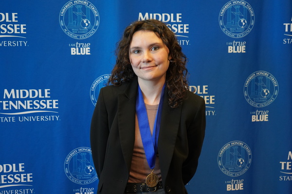 Representation of the achievement named 'Isabella Gilbert successfully defends Honors thesis at MTSU'.