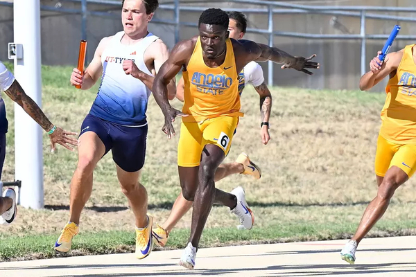 Angelo State sprinter William Opare taking a relay handoff on the track