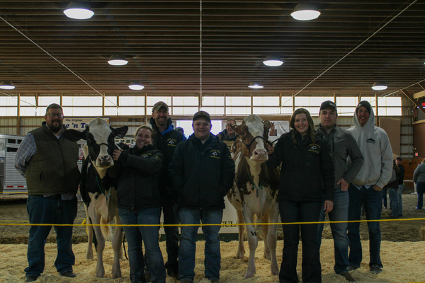 Dairy Society student sale chairs with the highest selling cows from the Green and Gold Spectacular Dairy Sale. (L-R: Brett Haines, Caitlyn VanDeusen '27, Josh Sanders '03, Jacob Vandoren '27, Nellie Hankinson '27, Joshua Martin, Aaron Ray Tompkins)