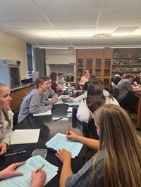 CU-Lock Haven students engaged in pre-lab discussion and worksheet analysis, preparing to understand real-time PCR concepts and experimental design.